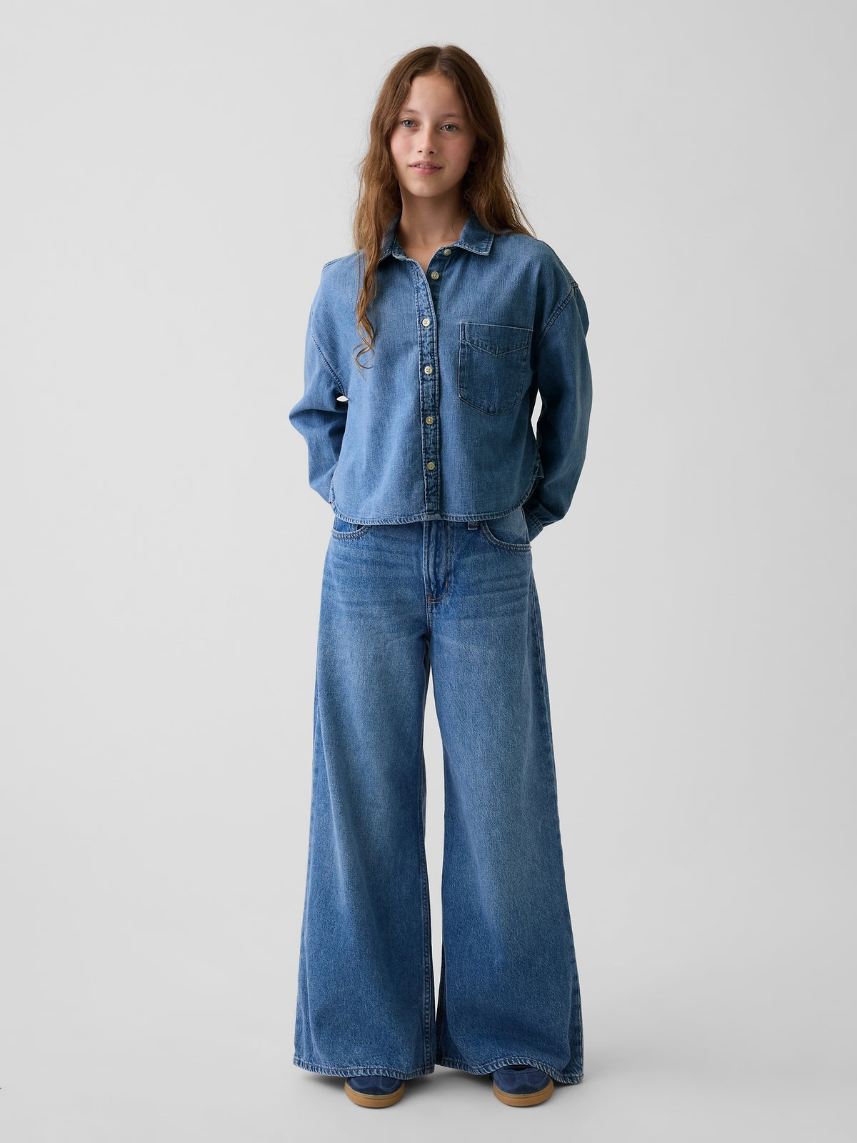 Gap Kids Low Rise Baggy Jeans in medium wash, front view with hands behind the back