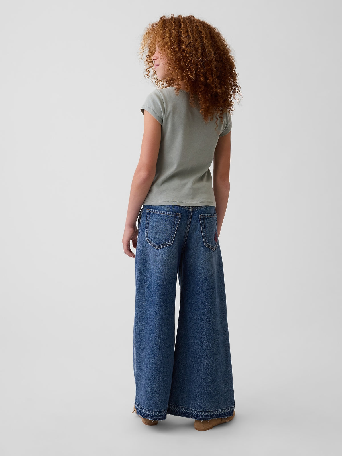 Gap Kids Low Rise Embroidered Baggy Jeans in Medium wash embroidery, back view on a child model