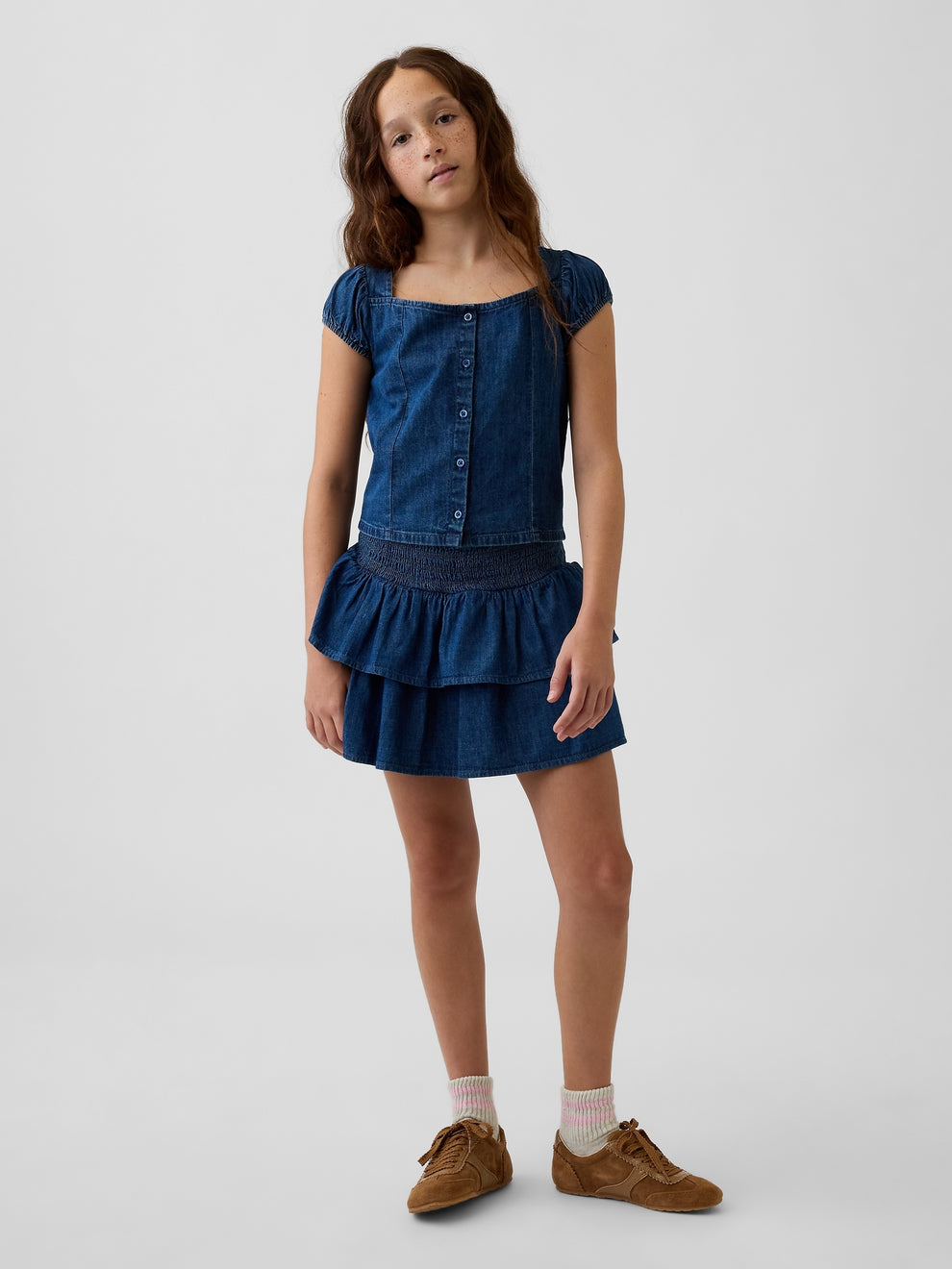 Gap Kids Denim Smocked Mini Skort in Dark wash, full-length view on a child model
