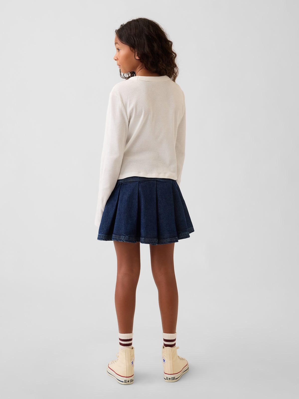 Gap Kids Denim Pleated Mini Skirt in Medium wash, back view on a child model