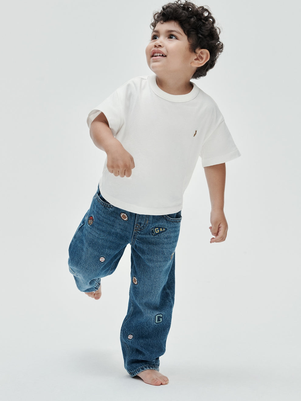 Gap Baby & Toddler Oversized T-Shirt in New off white, full-length view on a child model