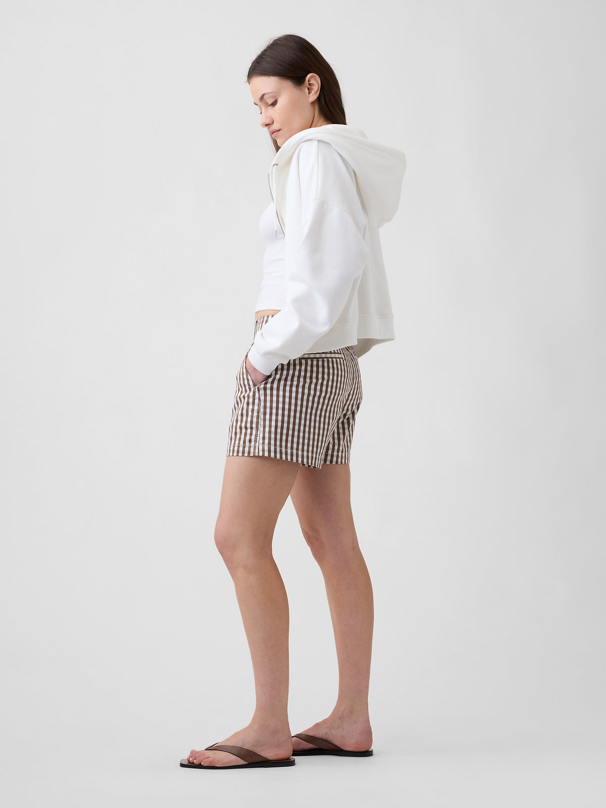 Gap 5" Mid Rise Downtown Khaki Shorts in Brown gingham, side view on a model