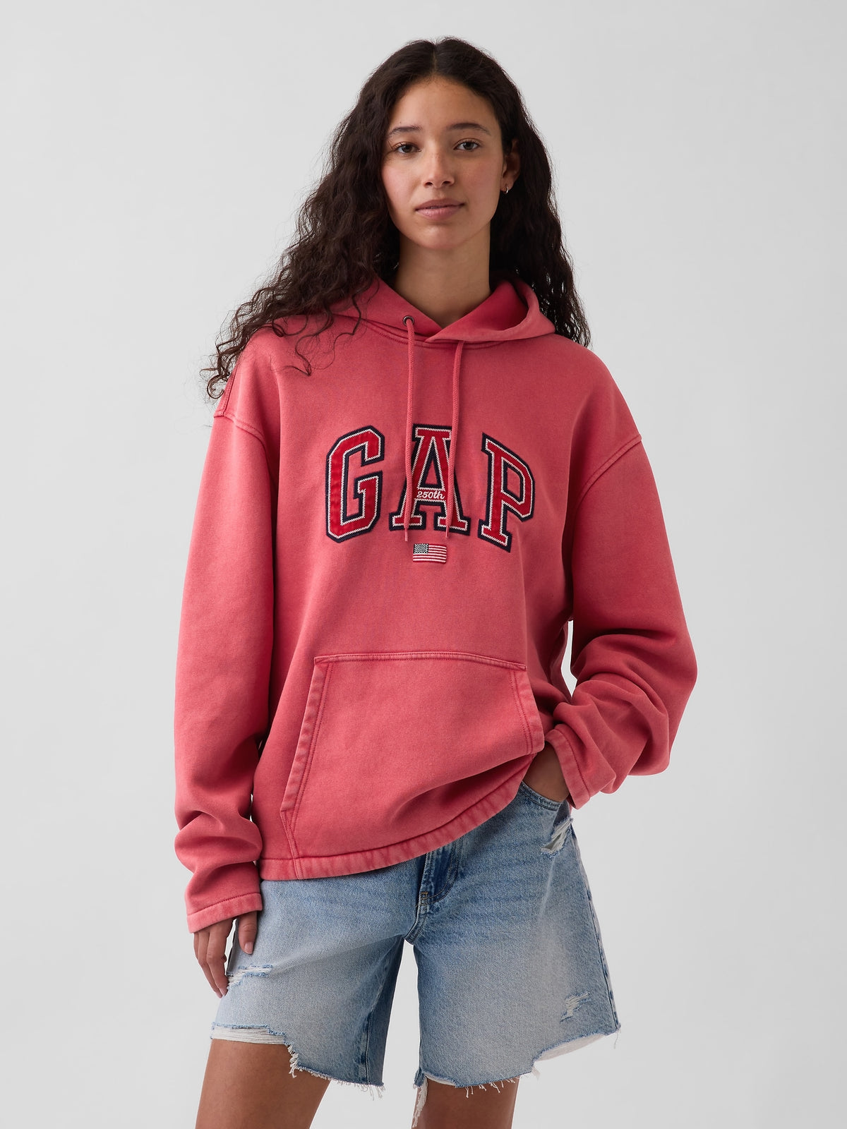 Gap VintageSoft Oversized Americana Logo Hoodie in faded red, front view on the first model